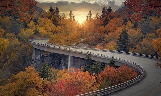 A Curvy Road During Autumn Through The Mountains