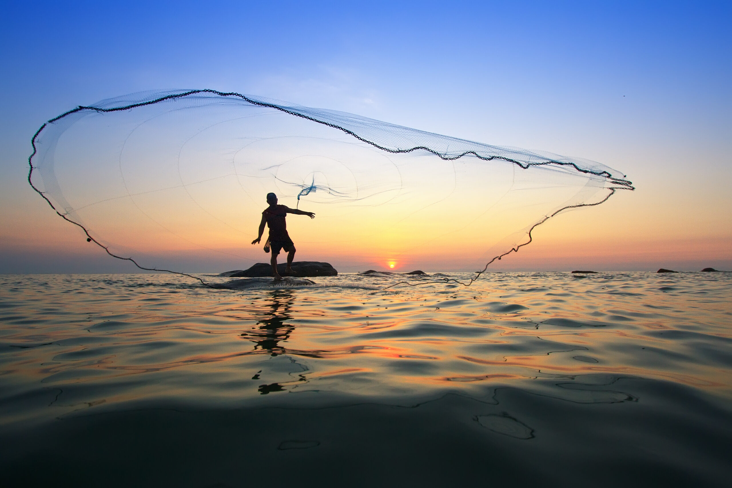 Throwing Fishing Net During Sunrise, Thailand